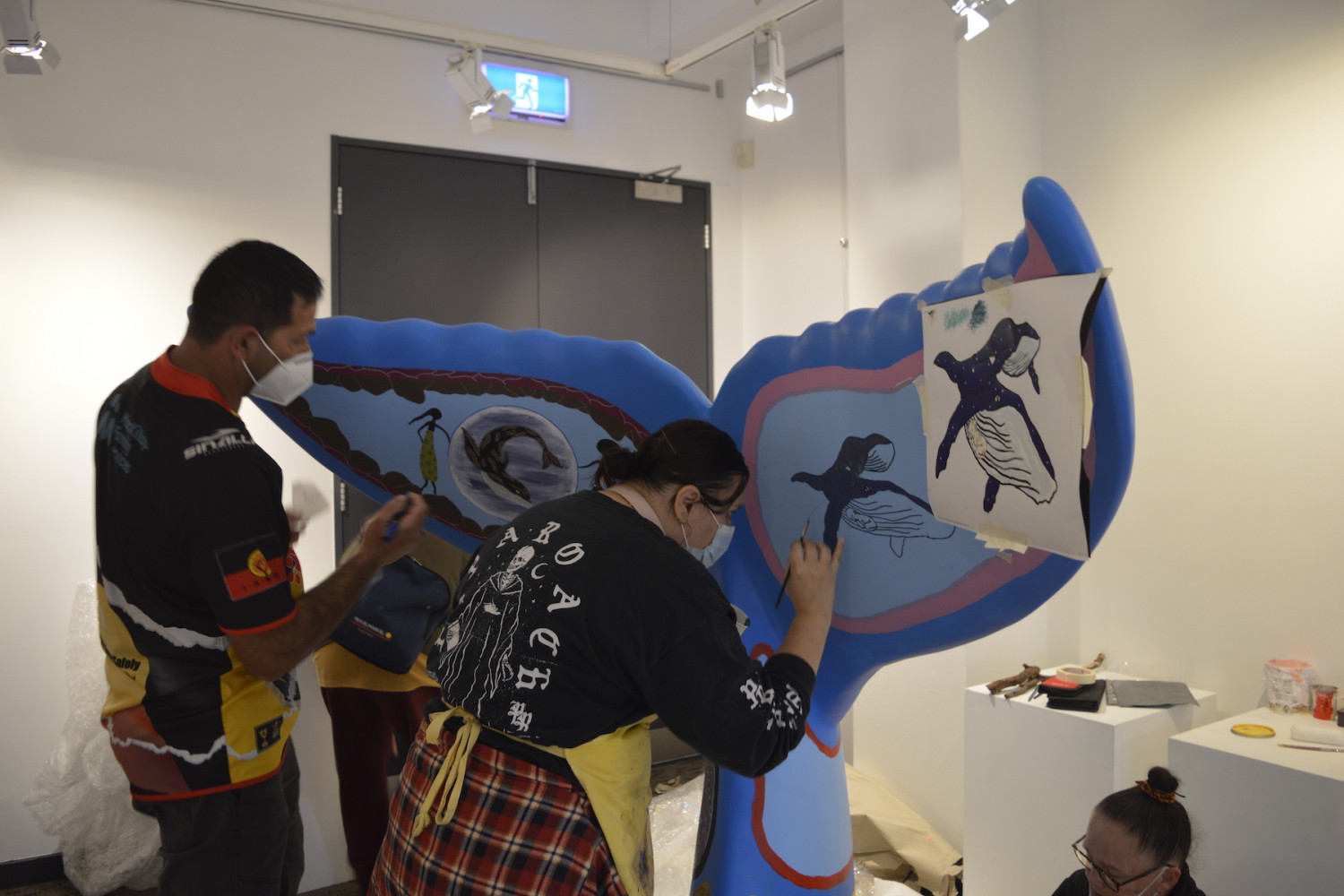 The students at TAFE NSW Eora painting their Whale Tale