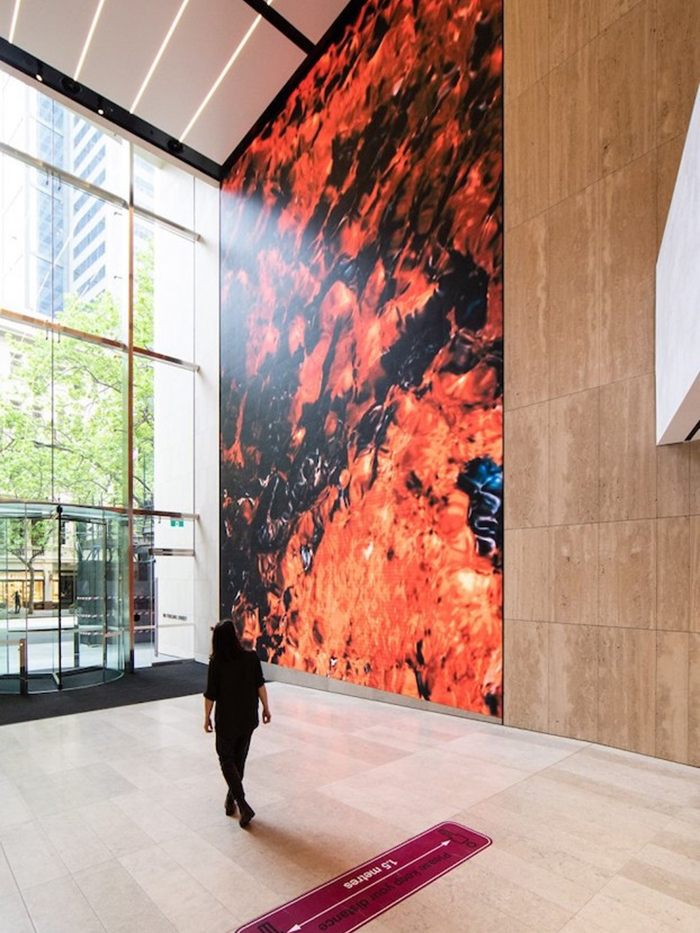 Digital work by Hampstead & Murray being admired at 80 Collins Street, Melbourne, November 2021. Image by Hilary Walker